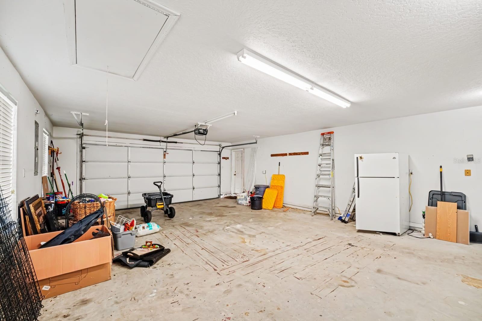 Spacious Two-Car Garage With Storage and Overhead Lighting