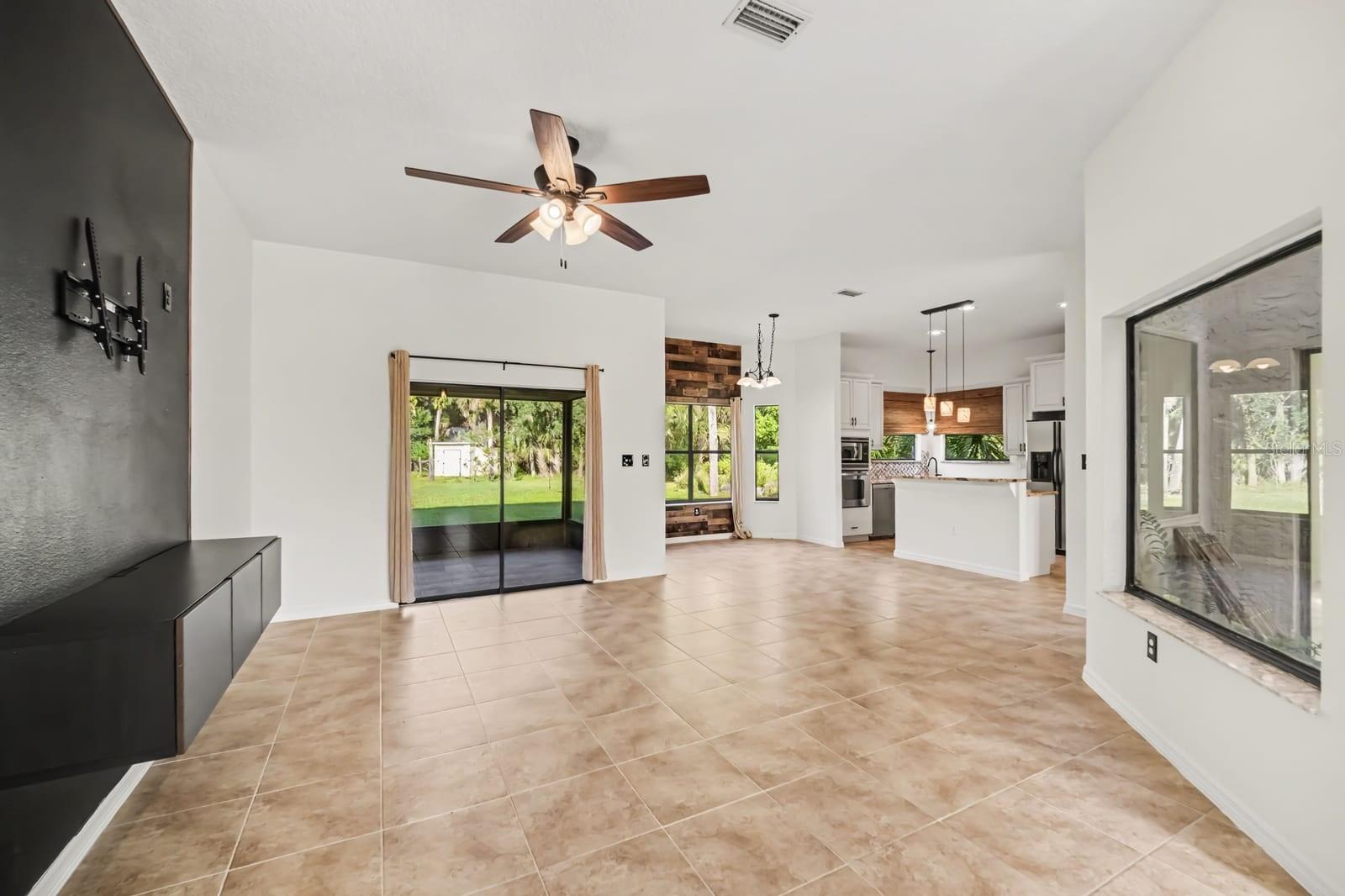 Open-concept living space connects to kitchen with sliding glass doors