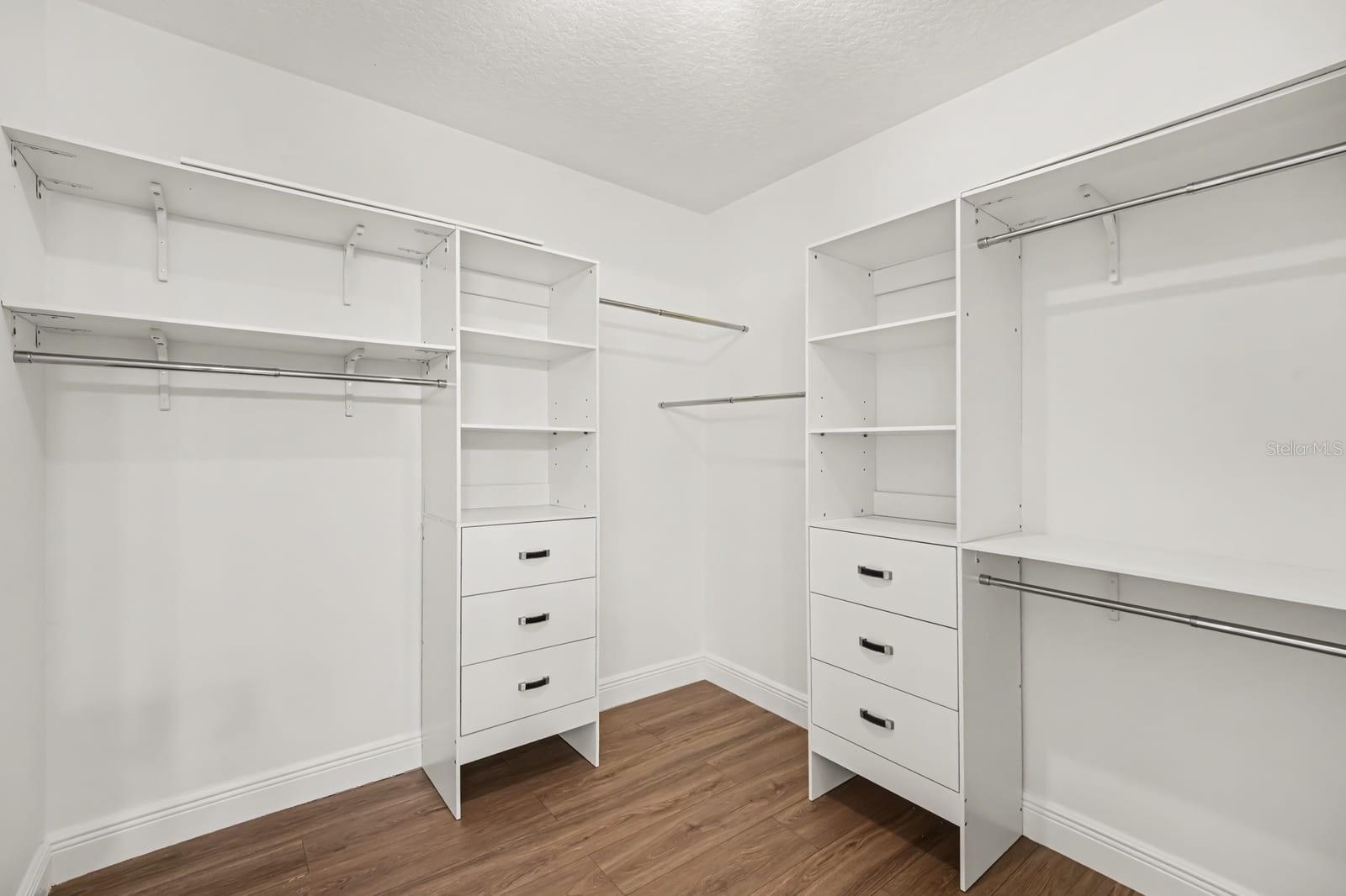 Walk-In Closet with Dual Clothing Rods, Shelving, and Drawer Storage