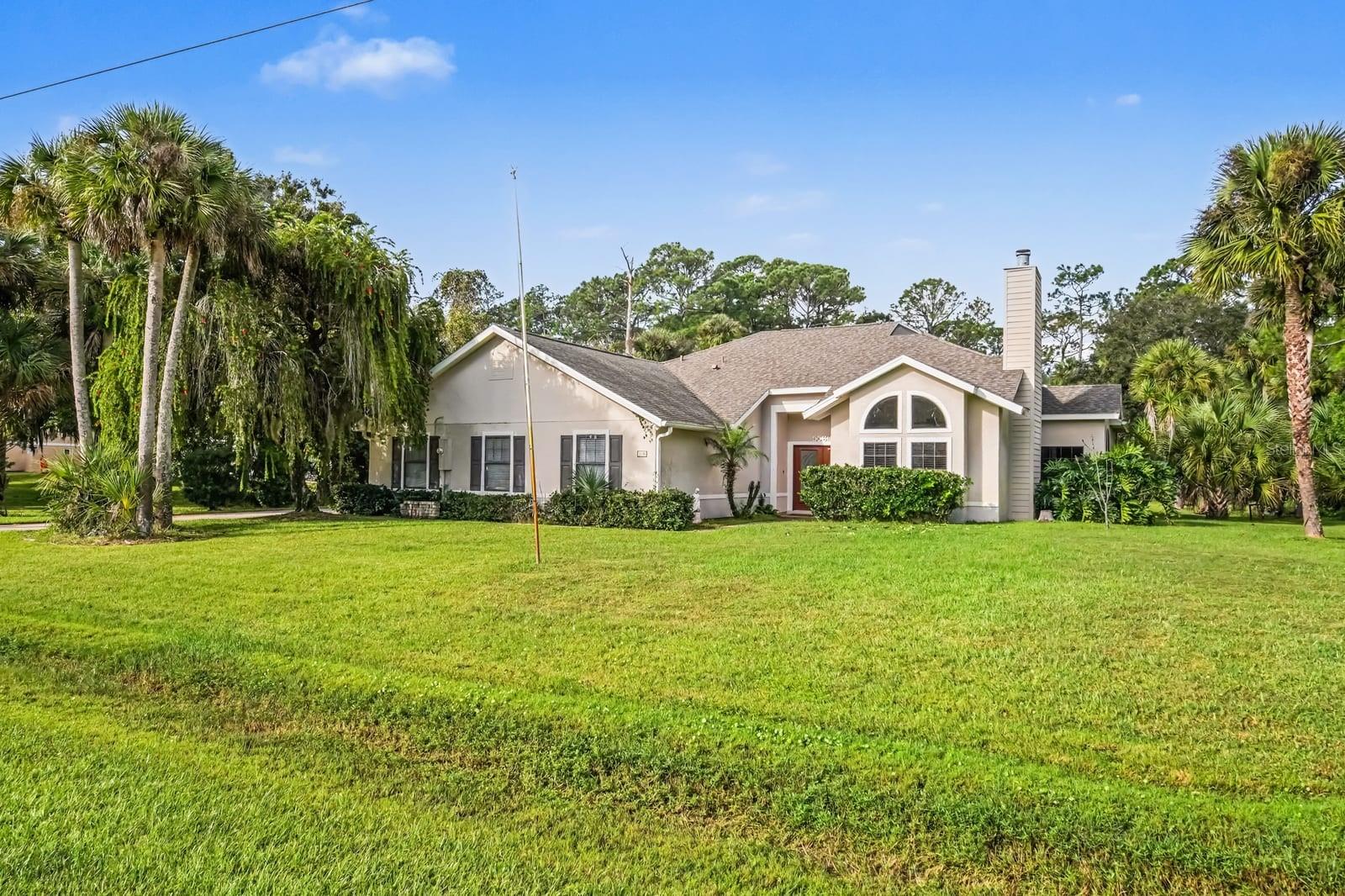 Elegant single-story residence nestled among native Florida landscape