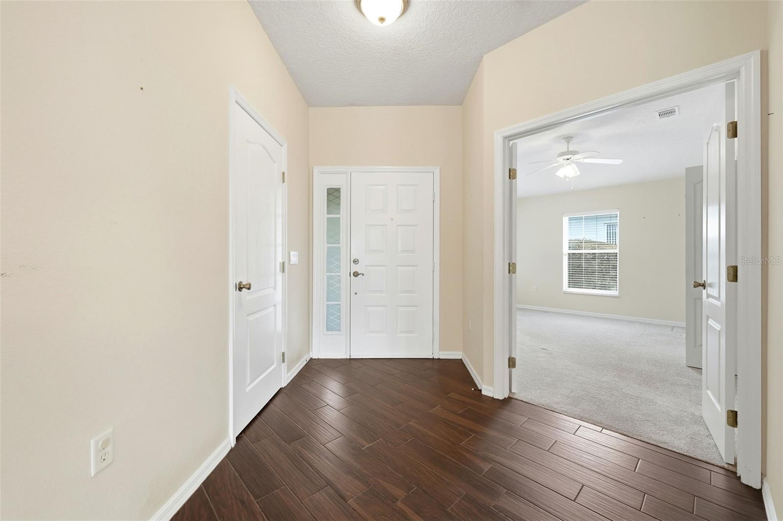 Inside entrance with coat closet and double doors to office/den or third bedroom