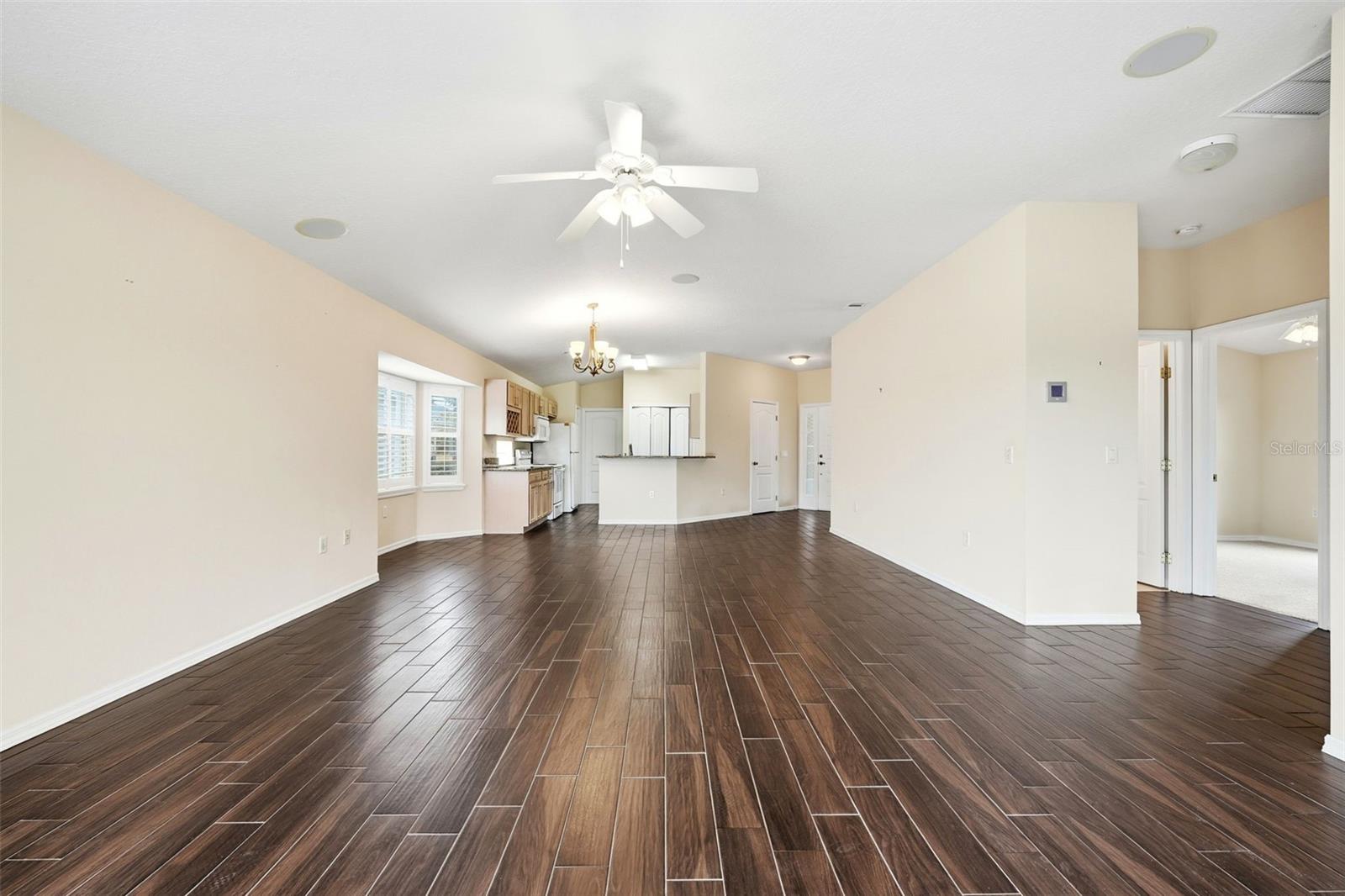 View from lanai into great room, dining, kitchen areas and hallway to Bedroom 2 and Guest Bath!