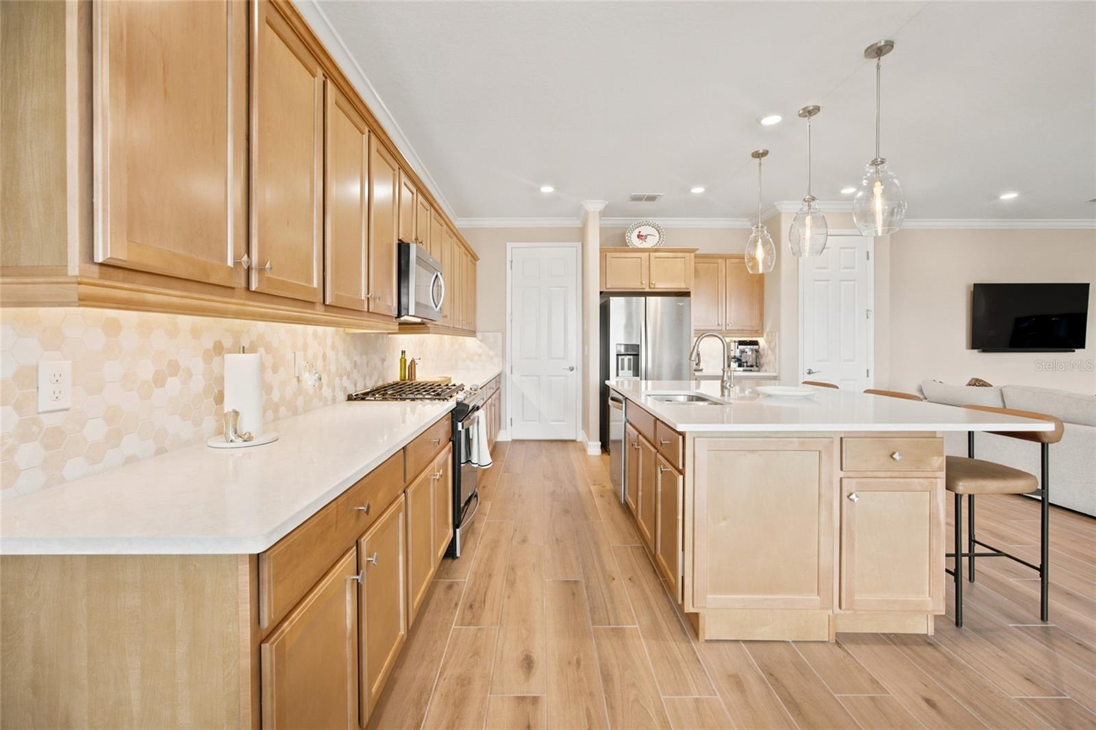 Long kitchen counter and cabinet layout providing abundant preparation and storage space.