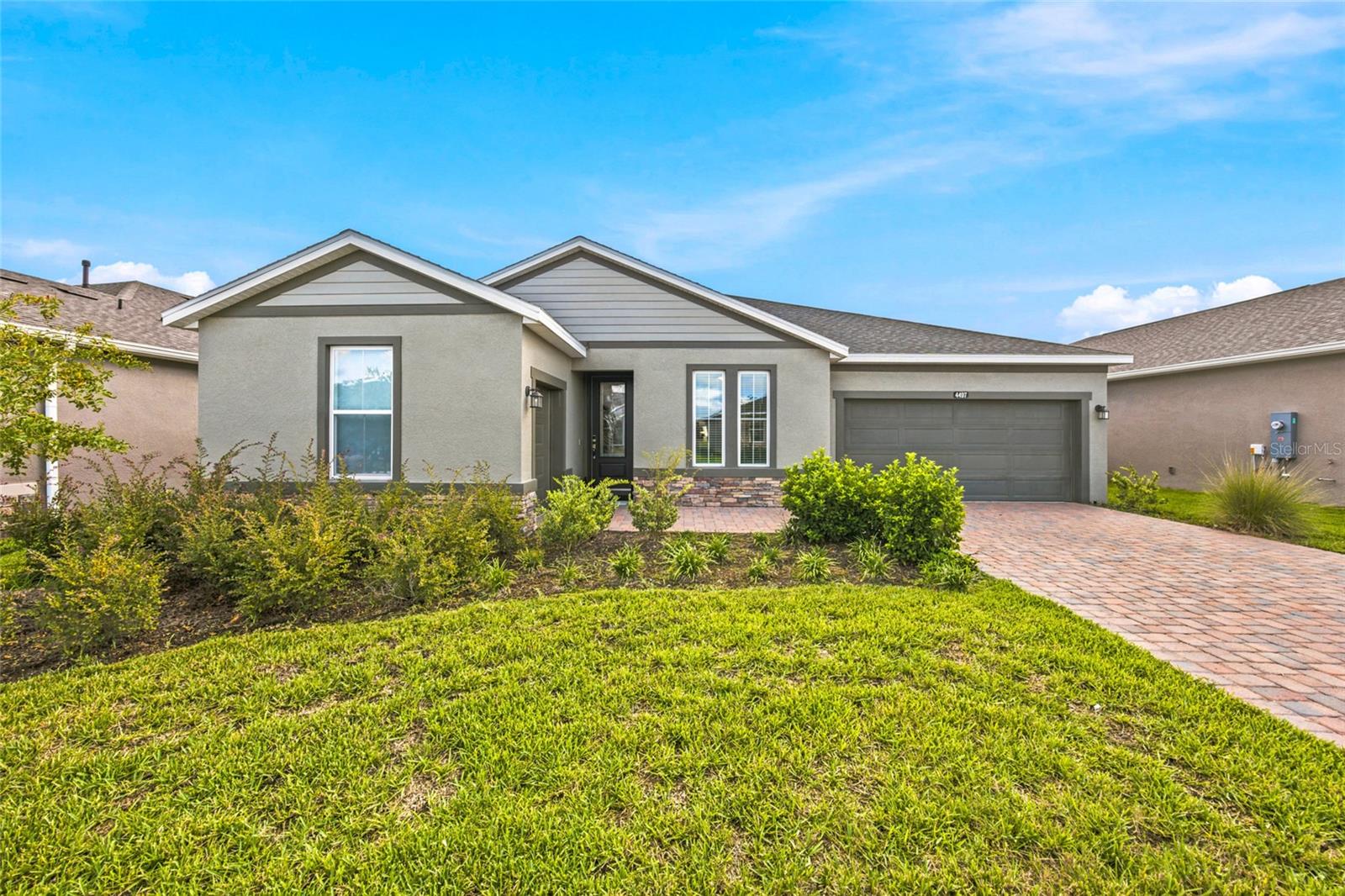 Welcoming front elevation with attractive landscaping, stone accents and a two-car garage. Welcoming front elevation with attractive landscaping, stone accents and a two-car garage.