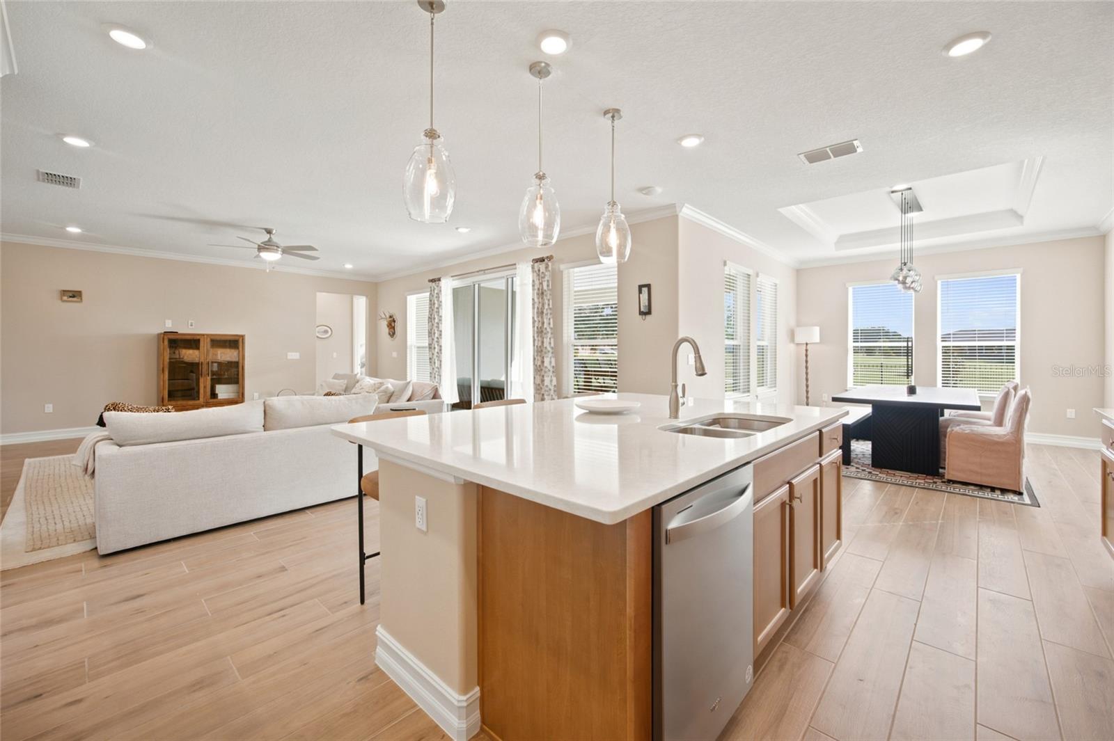 Open-concept design connecting the kitchen, living room and light-filled dining area.