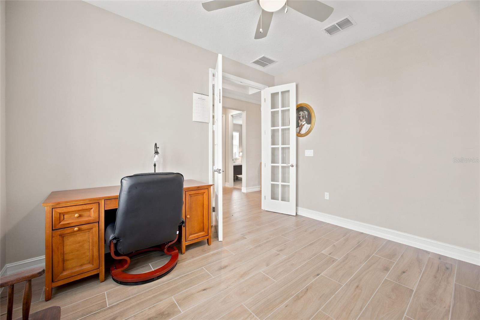 Second perspective of the private office with French doors.