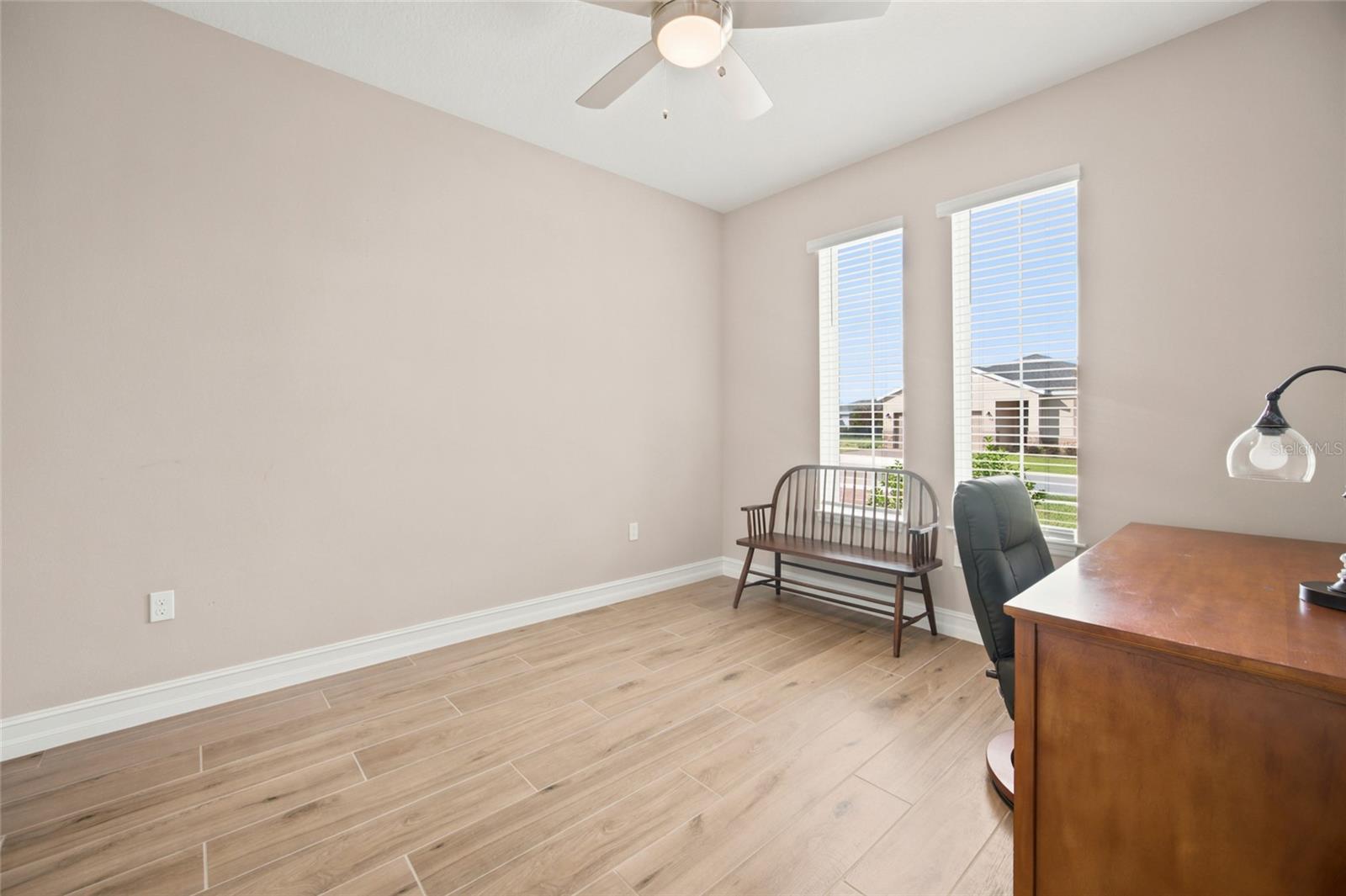 Dedicated home office with natural light and French-door entry.
