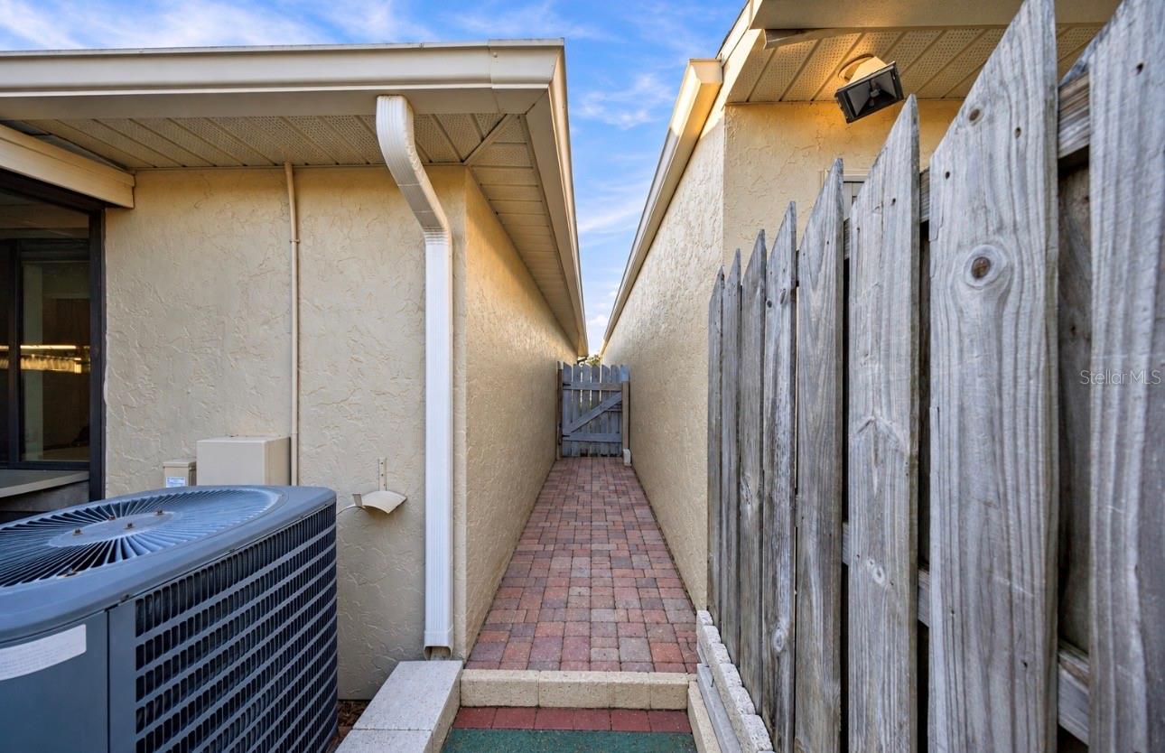 Brick paved side entry to back yard
