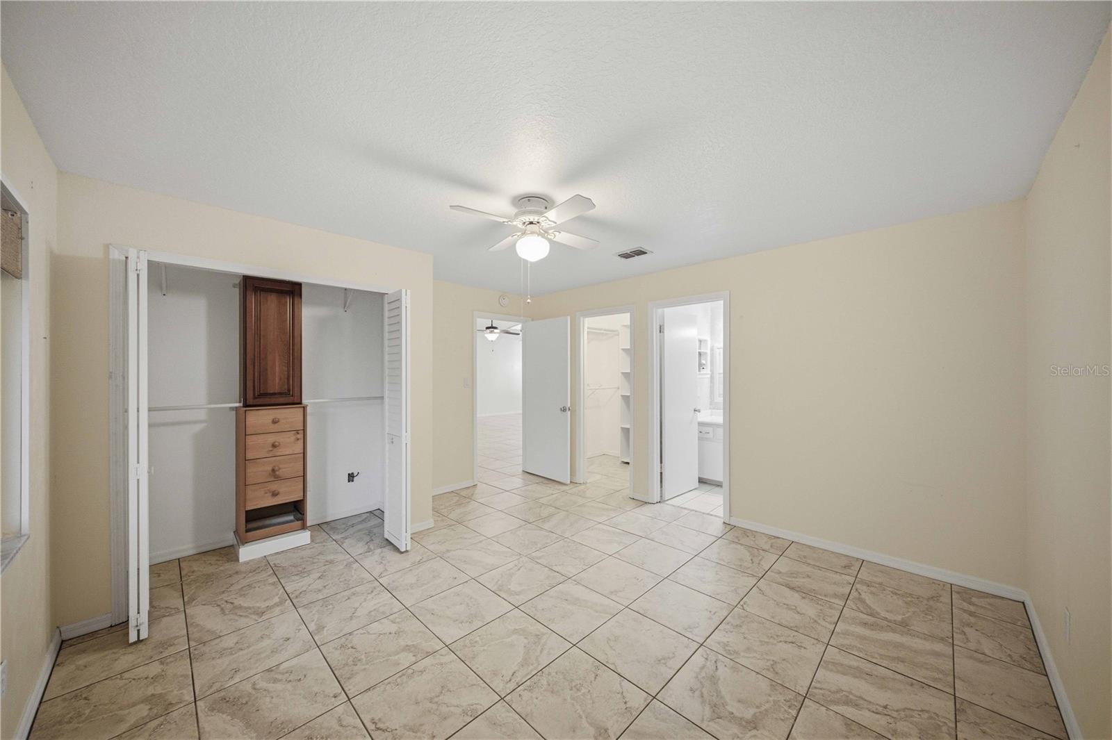 2nd closet with organizer in primary bedroom