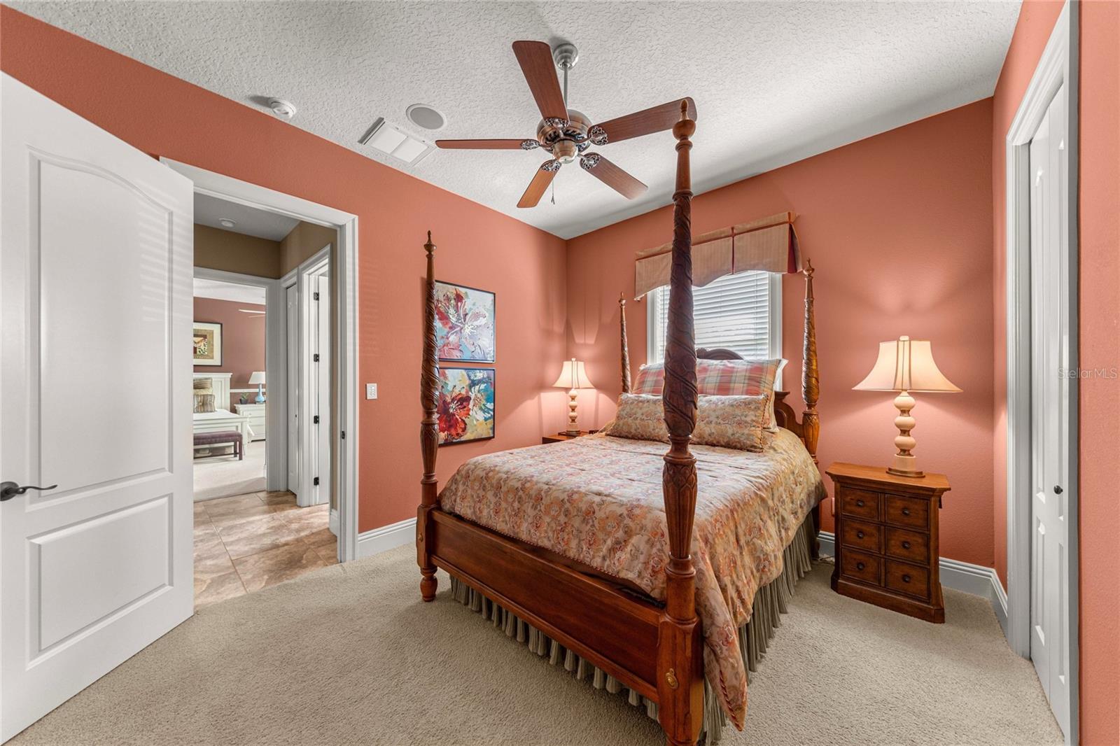 Additional view of the comfortable guest bedroom, showcasing its spacious layout, natural lighting, and convenient closet.