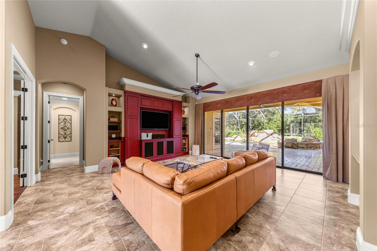 Open living space featuring custom entertainment wall. Open living space featuring custom entertainment wall.