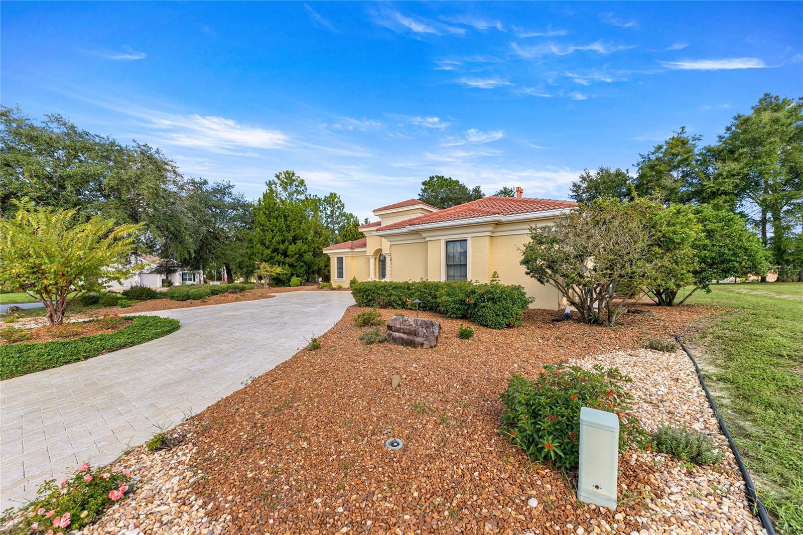 xterior View  Mediterranean-style home surrounded by mature landscaping and a spacious driveway.