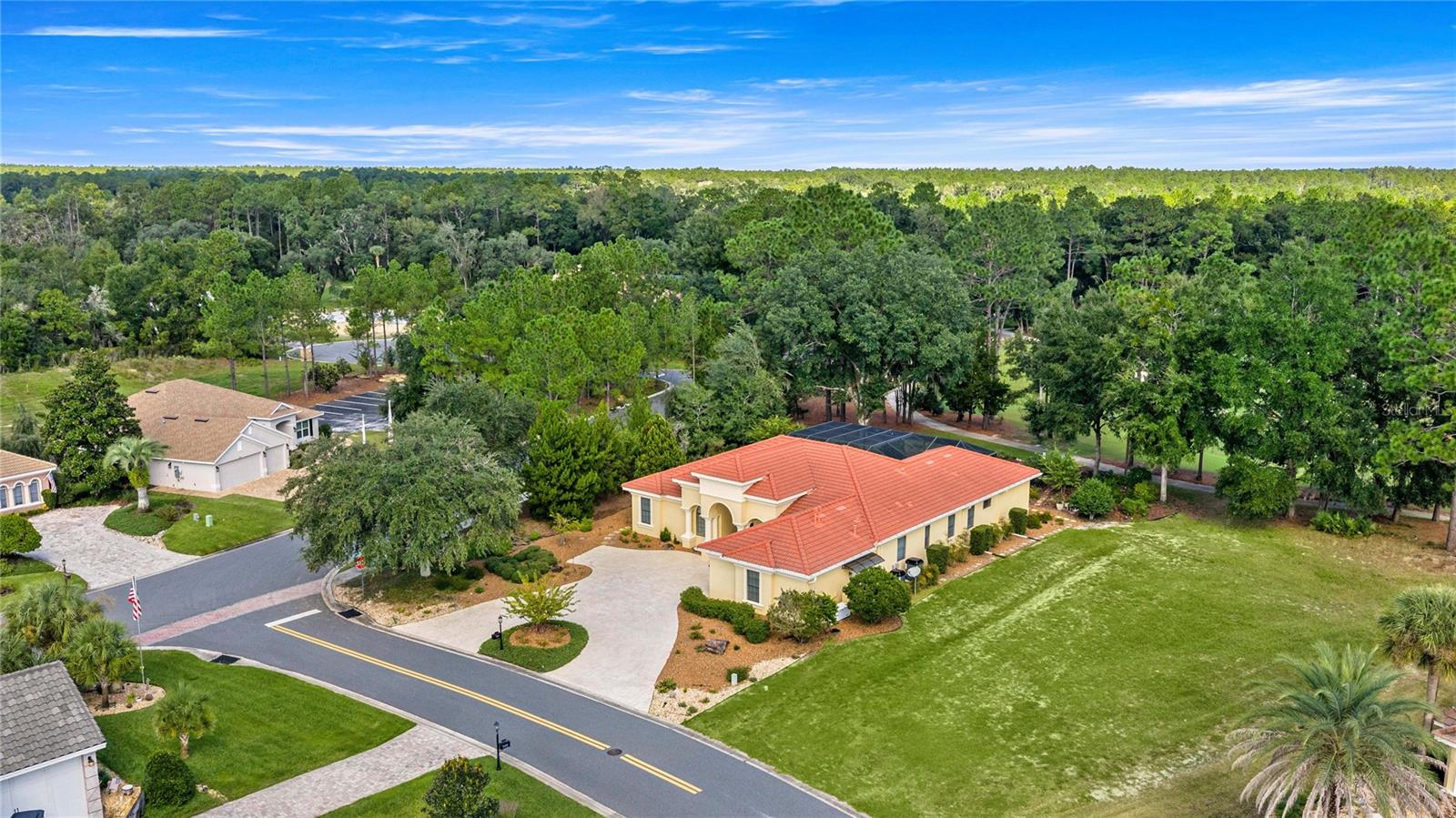 Spectacular aerial view showcasing the home's spacious setting, circular driveway, mature trees, and proximity to beautifully maintained golf course fairways. Spectacular aerial view showcasing the home's spacious setting, circular driveway, mature trees, and proximity to beautifully maintained golf course fairways.