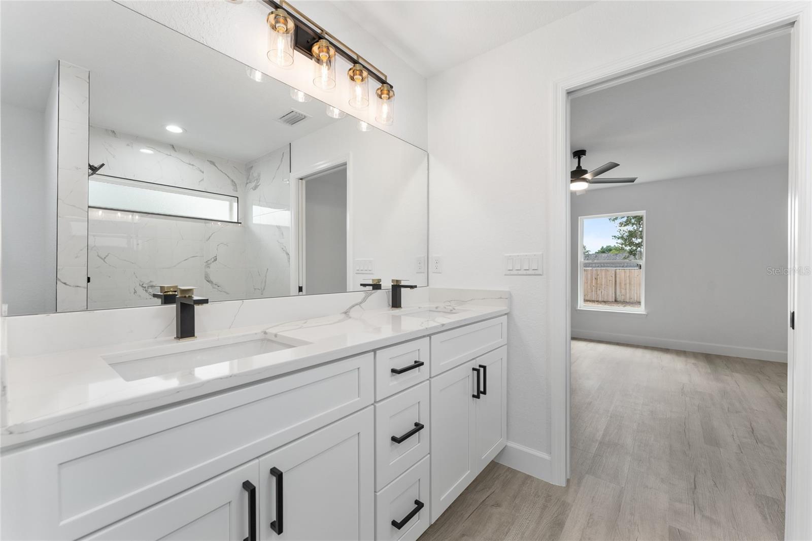 Primary Bathroom. Actual home will not have gold finishes, only black