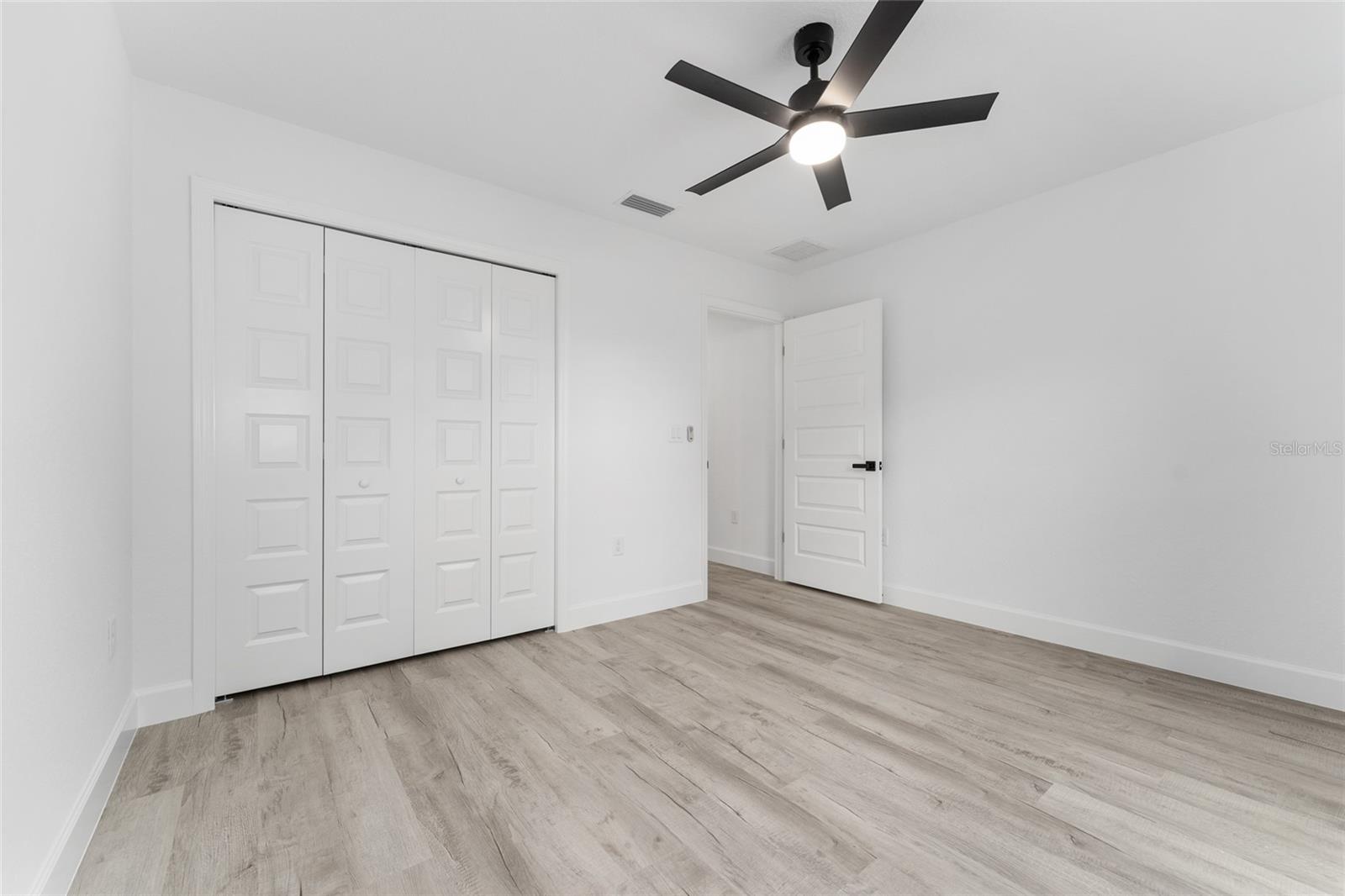 Bedroom 2. Actual home will have colonial-style interior doors versus what is shown.