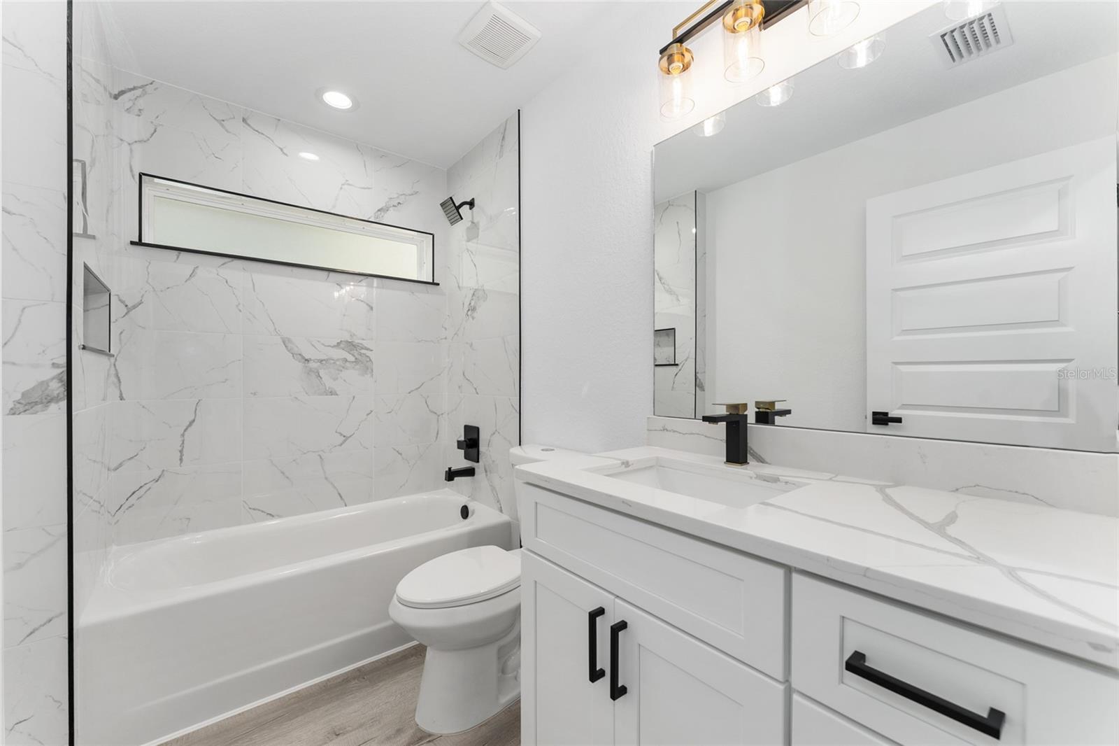 Guest Bath. Actual home will not have gold finishes, only black