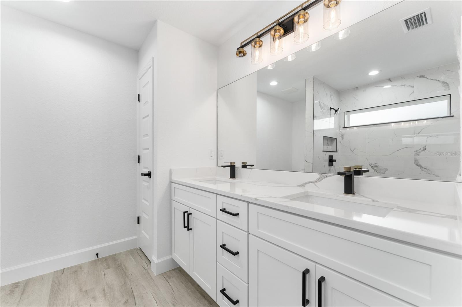 Primary Bathroom. Actual home will not have gold finishes, only black