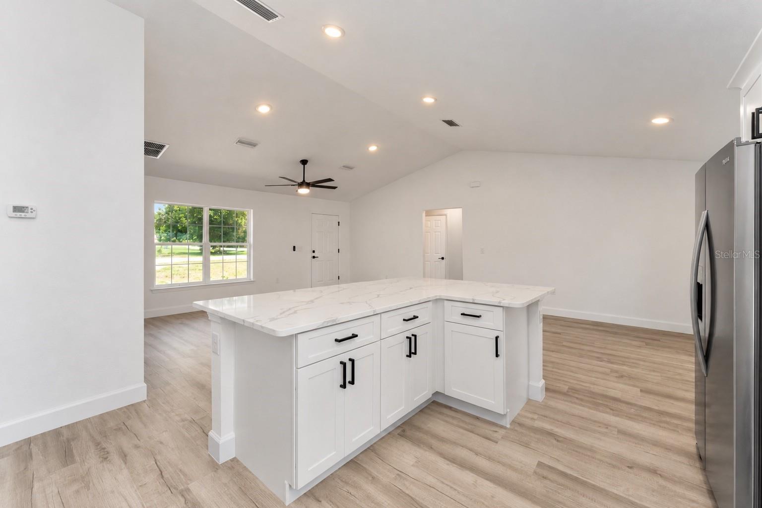 Virtually altered kitchen island without pendents.