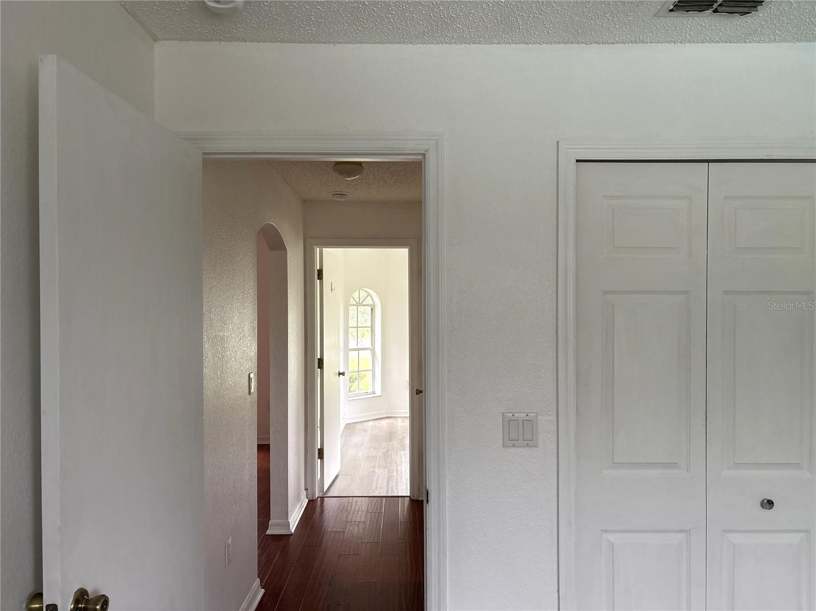 From second bedroom looking down hallway toward guest bath and first guest bedroom
