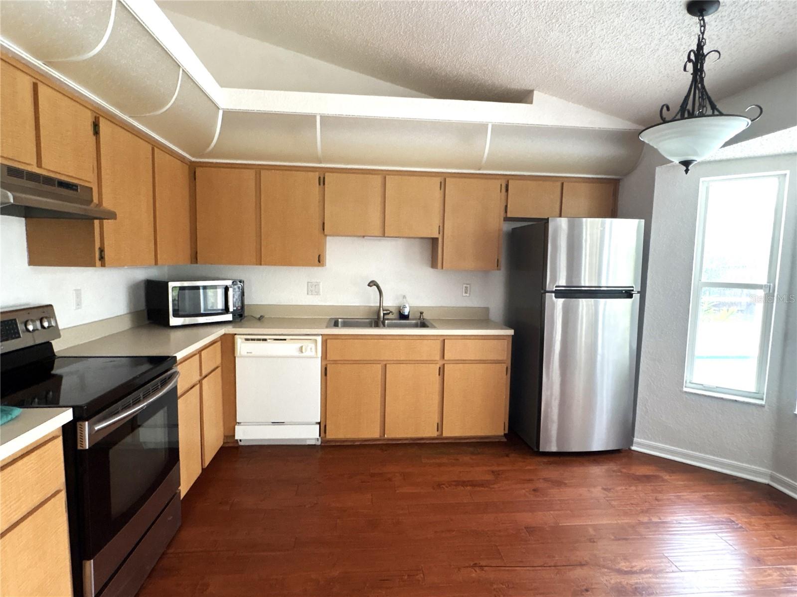 Open kitchen with small eat in kitchen area.