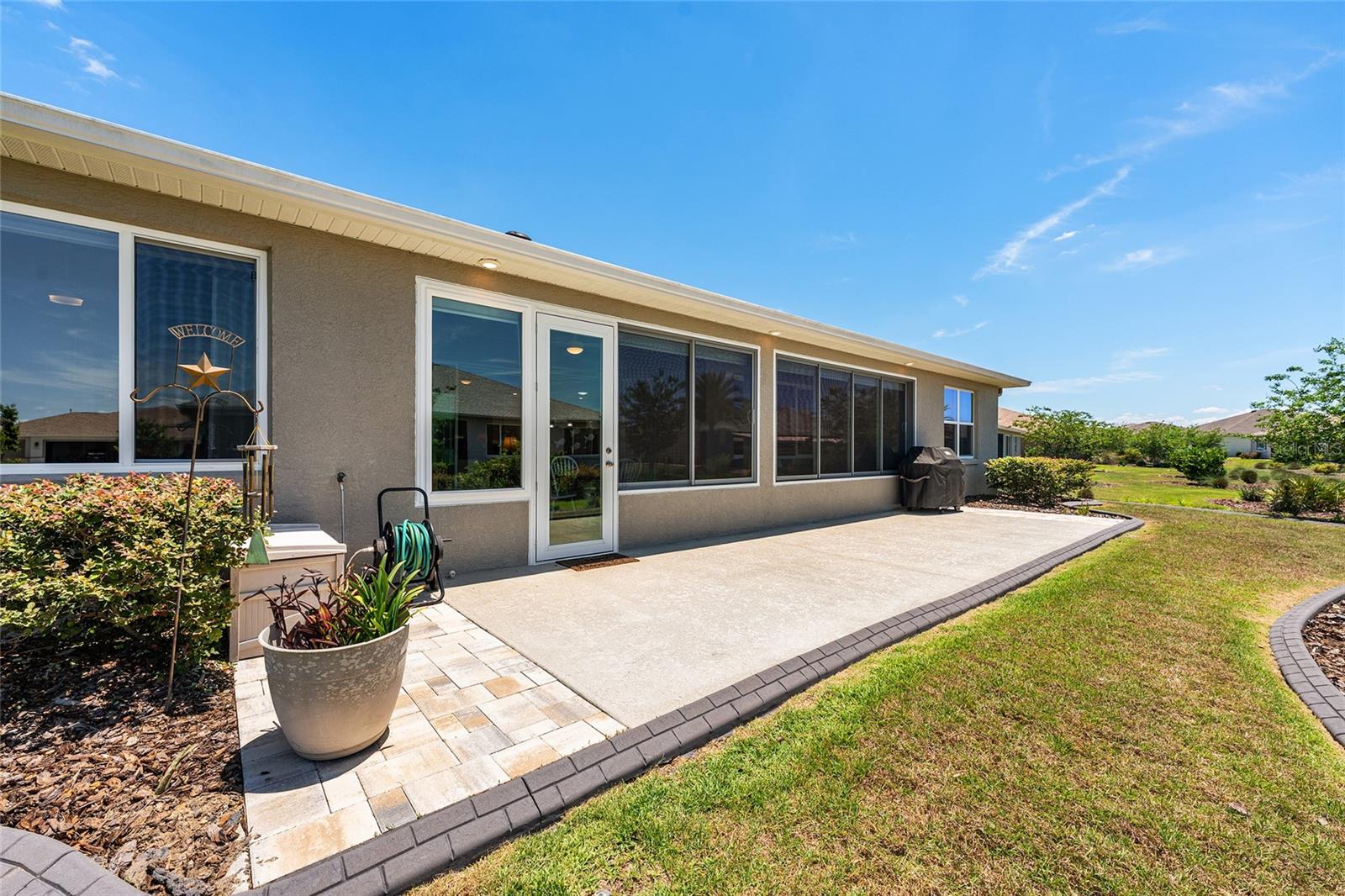 Expansive 38' x 10' patio featuring soffit lighting and a dedicated gas line for the included barbecue grill. Overlooking the beautifully landscaped backyard, this spacious outdoor retreat is ideal for grilling, entertaining, or simply enjoying Florida's beautiful weather.