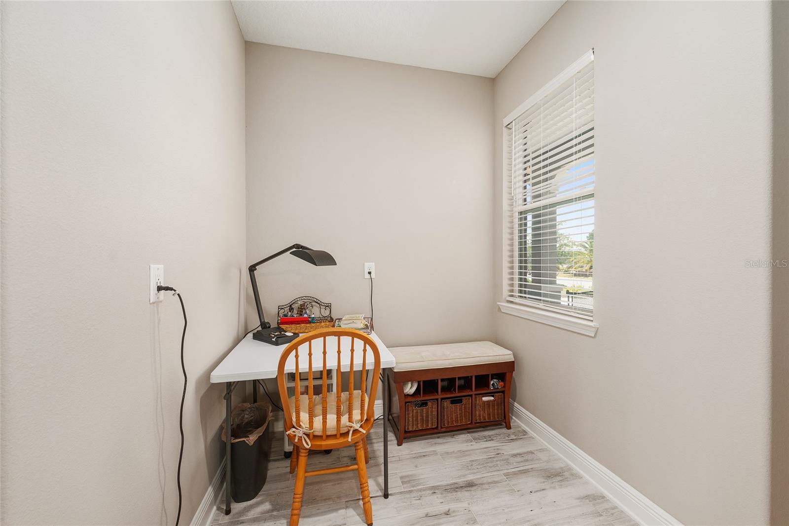 Versatile bonus space conveniently located off the two-car garage and near the pantry, offering the perfect spot for a secondary home office, hobby area, or organized everyday drop zone.