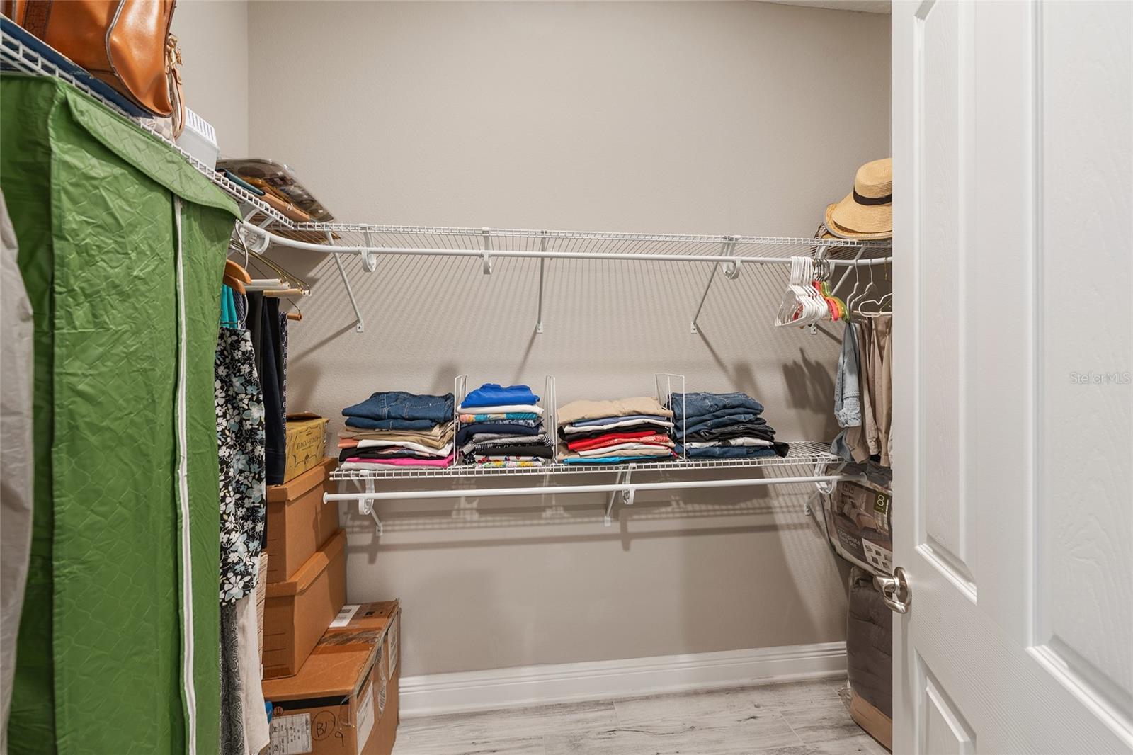 Second walk-in closet in the primary suite, offering additional shelving and hanging space to keep clothing and accessories neatly organized.