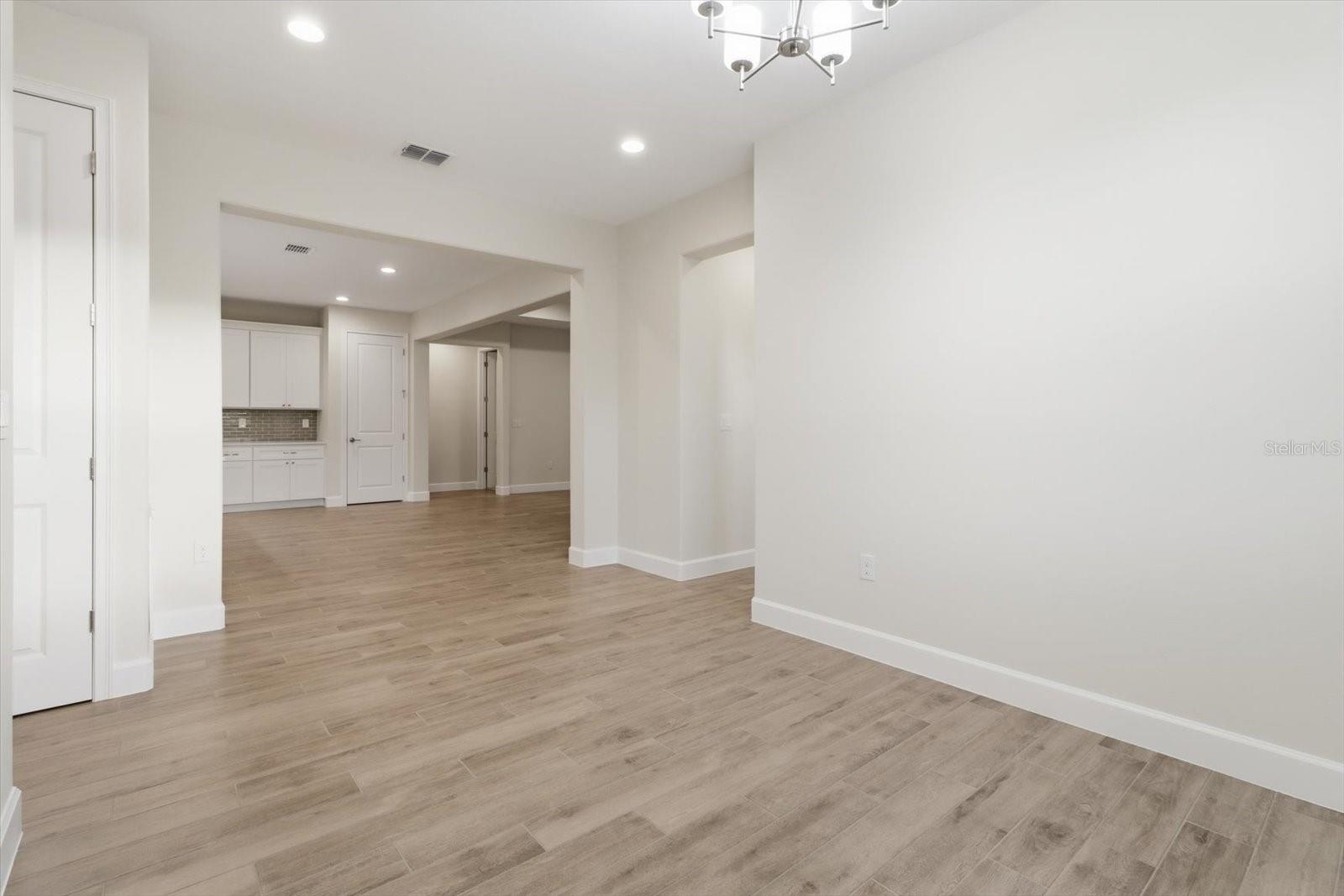 The breakfast nook is just off the side of the kitchen, next to the laundry room.