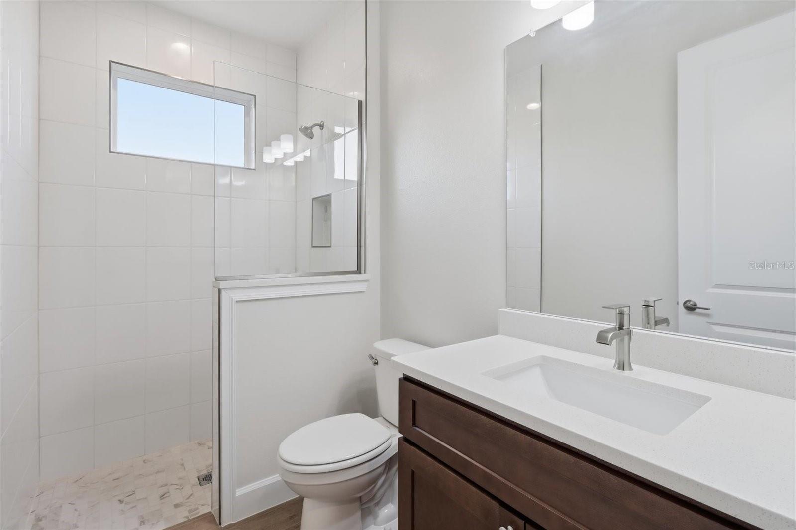 Bathroom 3 with a tiled walk in shower.