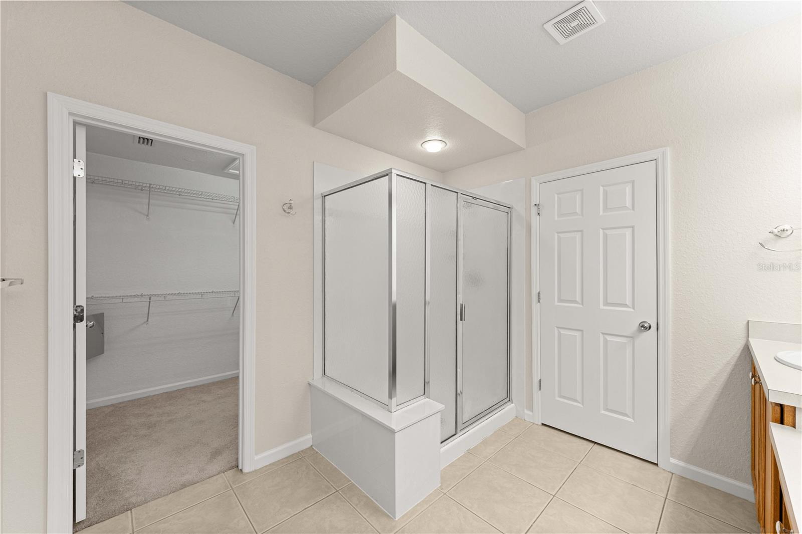 Primary en suite bathroom with walk in shower