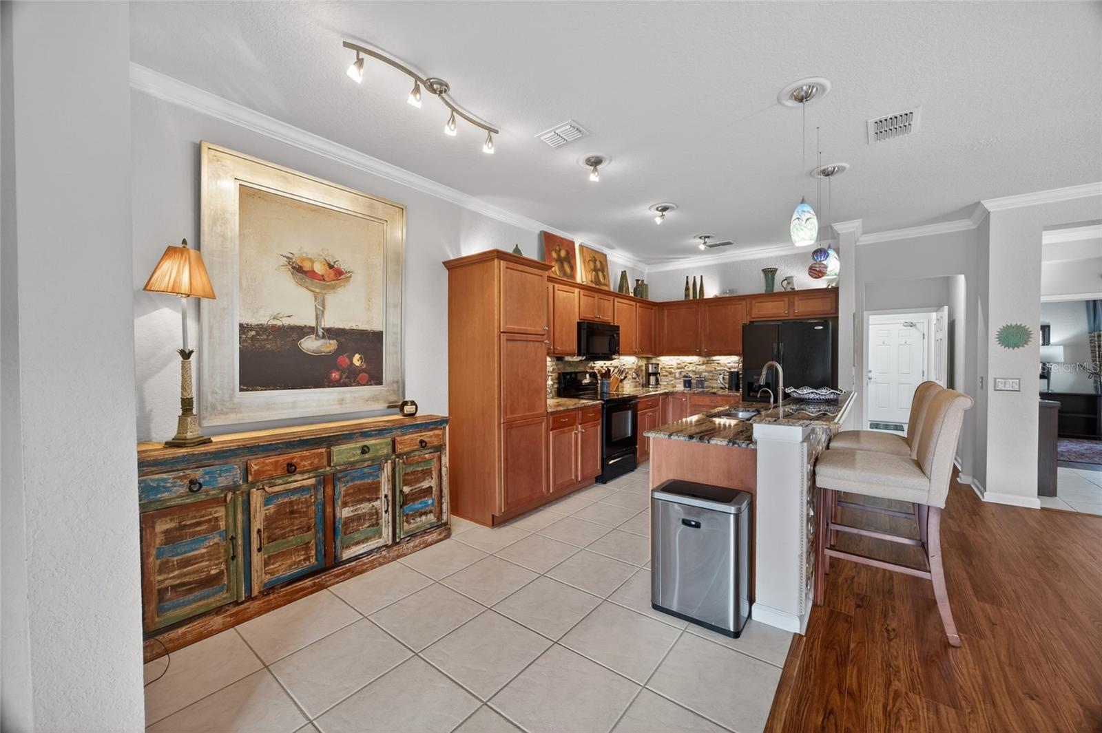Kitchen with lots of storage, bright lights and space for socializing  and enjoying meals.