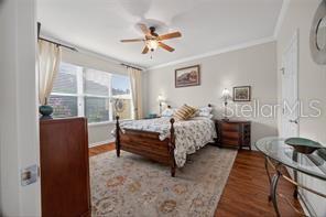 Prime bedroom with a sleep number king size bed, crown molding and luxury vinyl flooring.