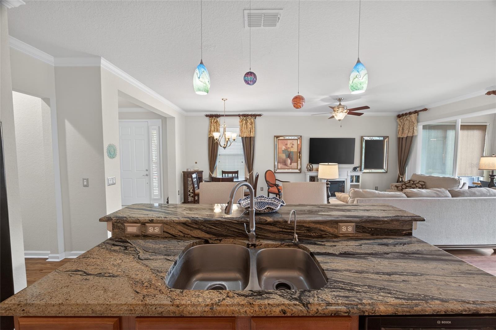 This home has an extended patio that is enclosed with glass doors that stack to open for lots of fresh air and sunshine.