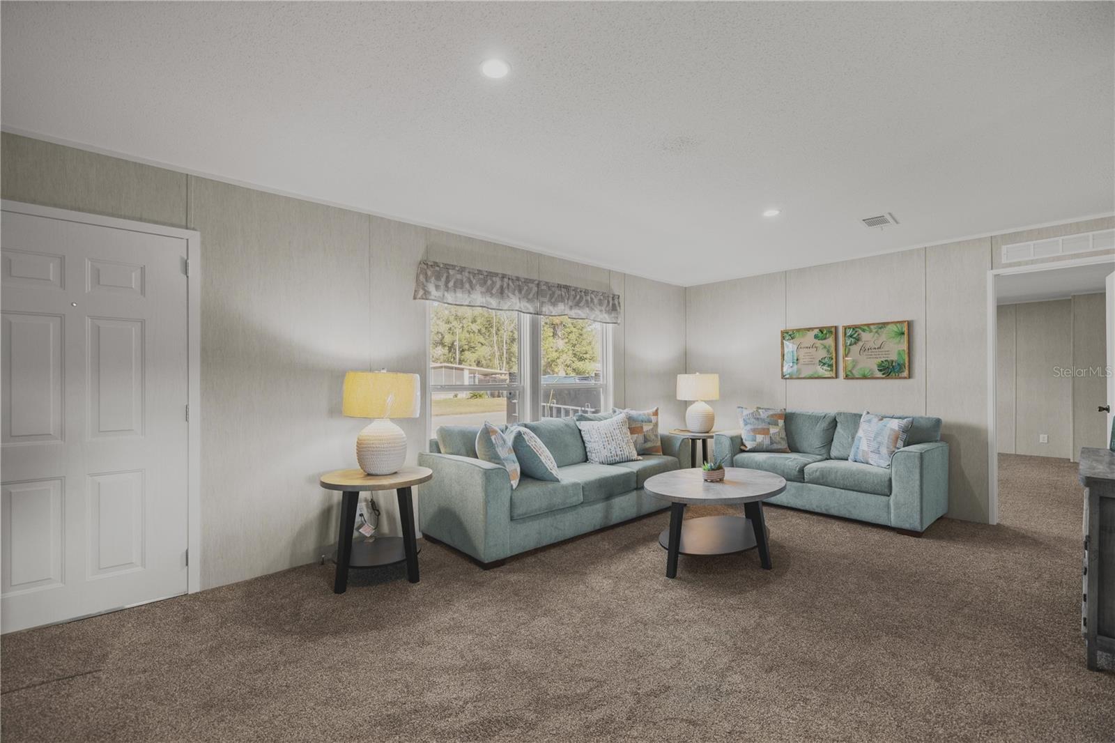 Enter into the bright living room with vaulted ceilings