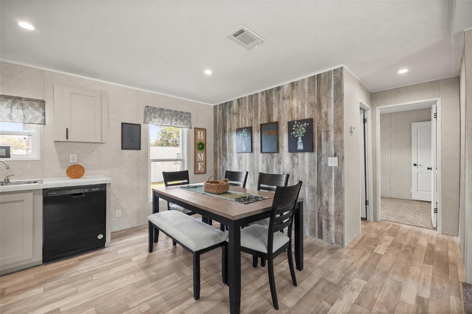 Dining Room open to kitchen with Wood look wall