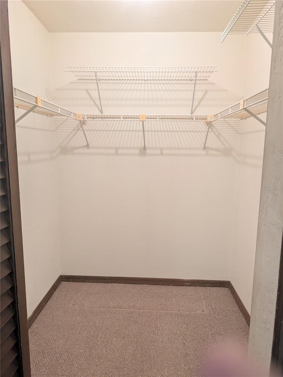 Primary bedroom walk in closet