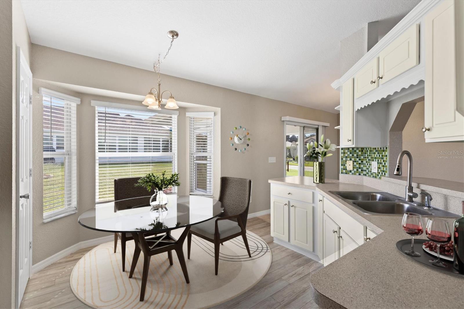 Virtually staged eat-in kitchen.