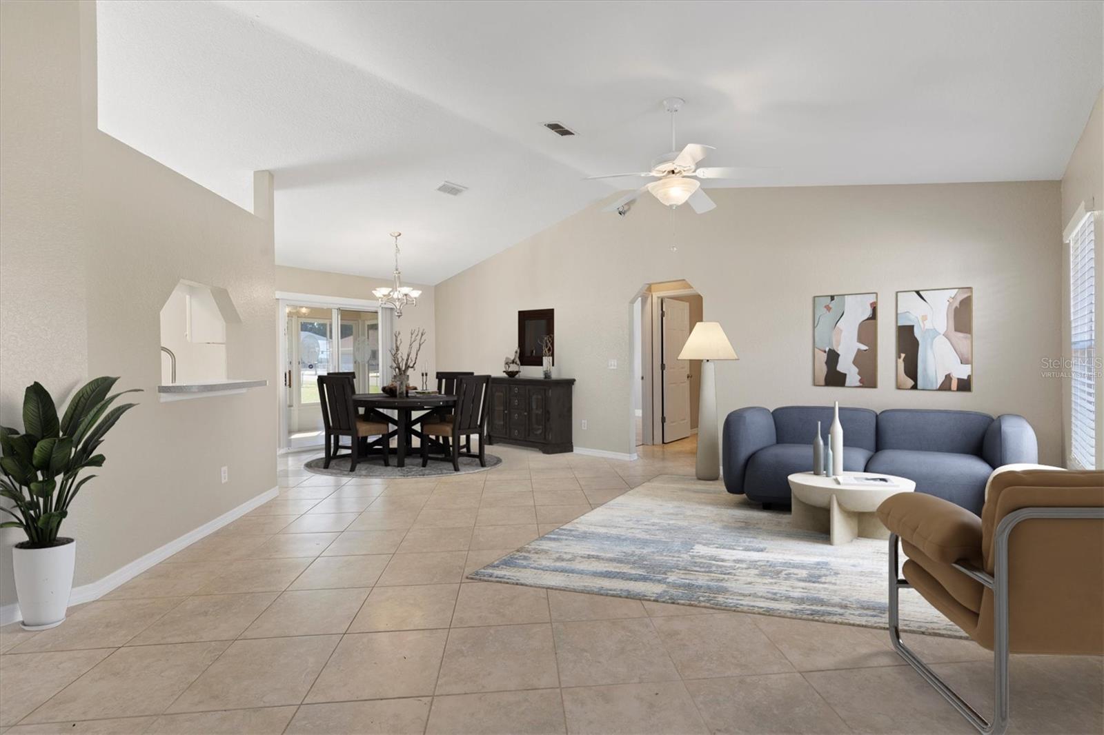 Virtually staged living room with dining room.