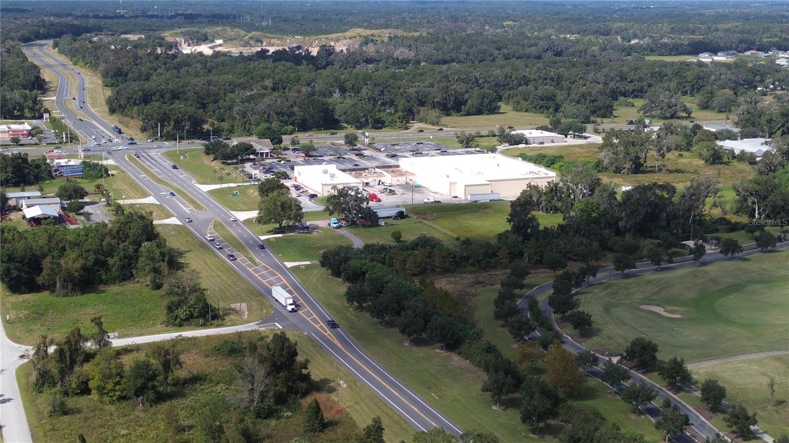 VIEW IS DIRECTLY ABOVE THE VACANT LOT SHOWING DISTINCE TO SHOPPING CENTER
