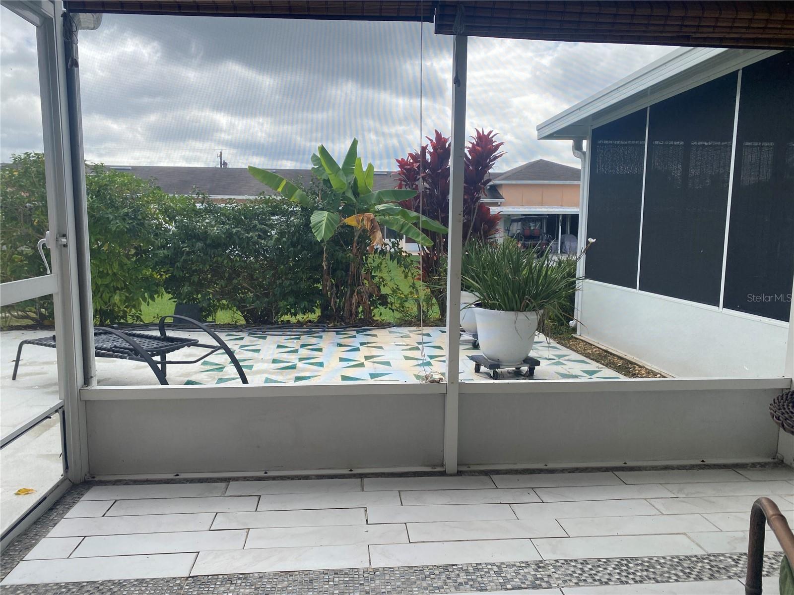 Back screened porch opens to a private courtyard - landscaping provides the privacy.