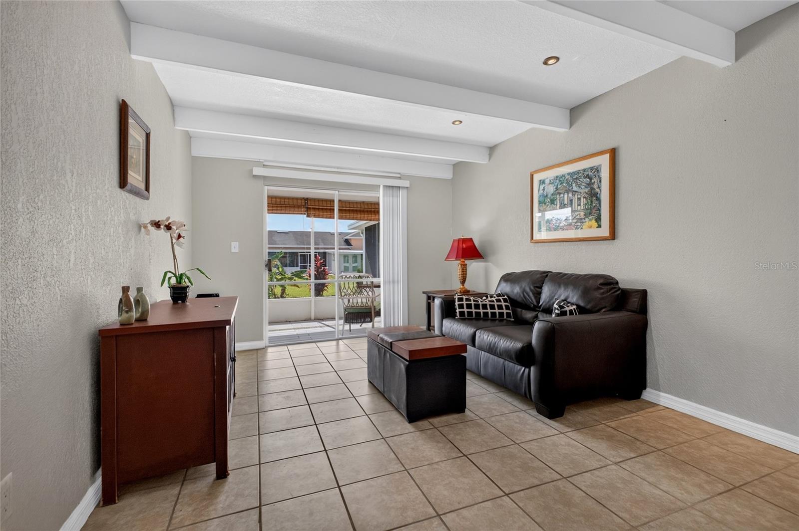 The living room is 11' x 14' with a sliding glass door that opens to the back screened porch.