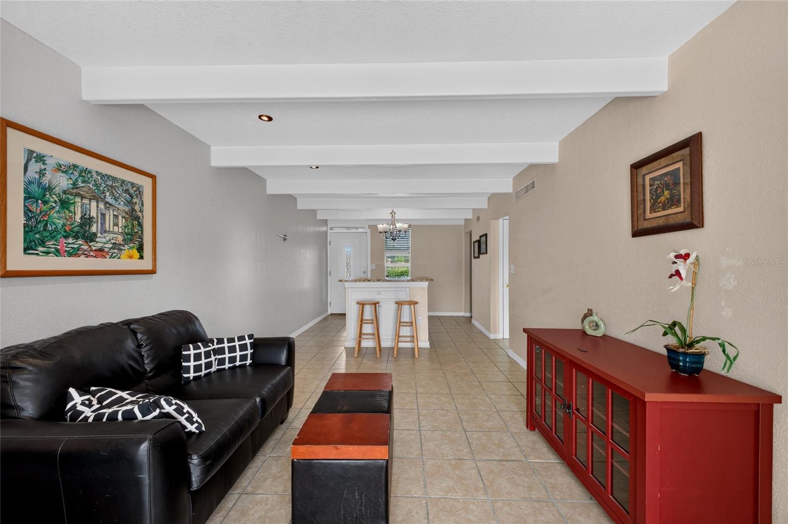 Looking from the living room to the dining area and the front door.