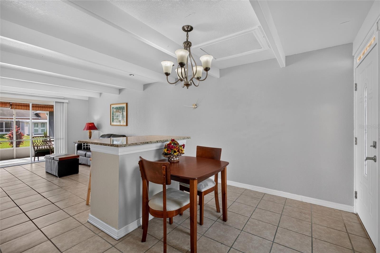 Open floor plan.  High ceilings.  Lots of natural light filters into the home. Granite on the breakfast bar and ceramic tile flooring.