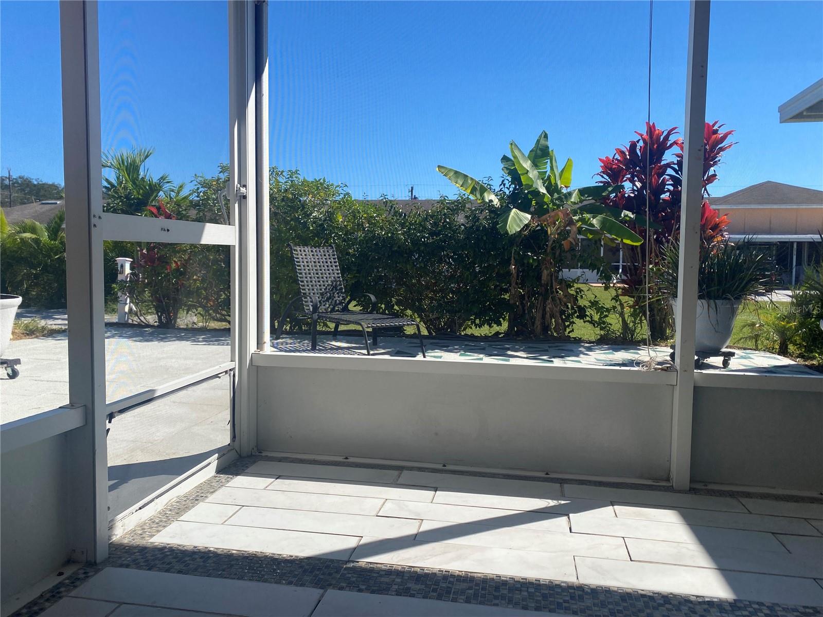 Back screened porch opens to a private courtyard - landscaping provides the privacy.