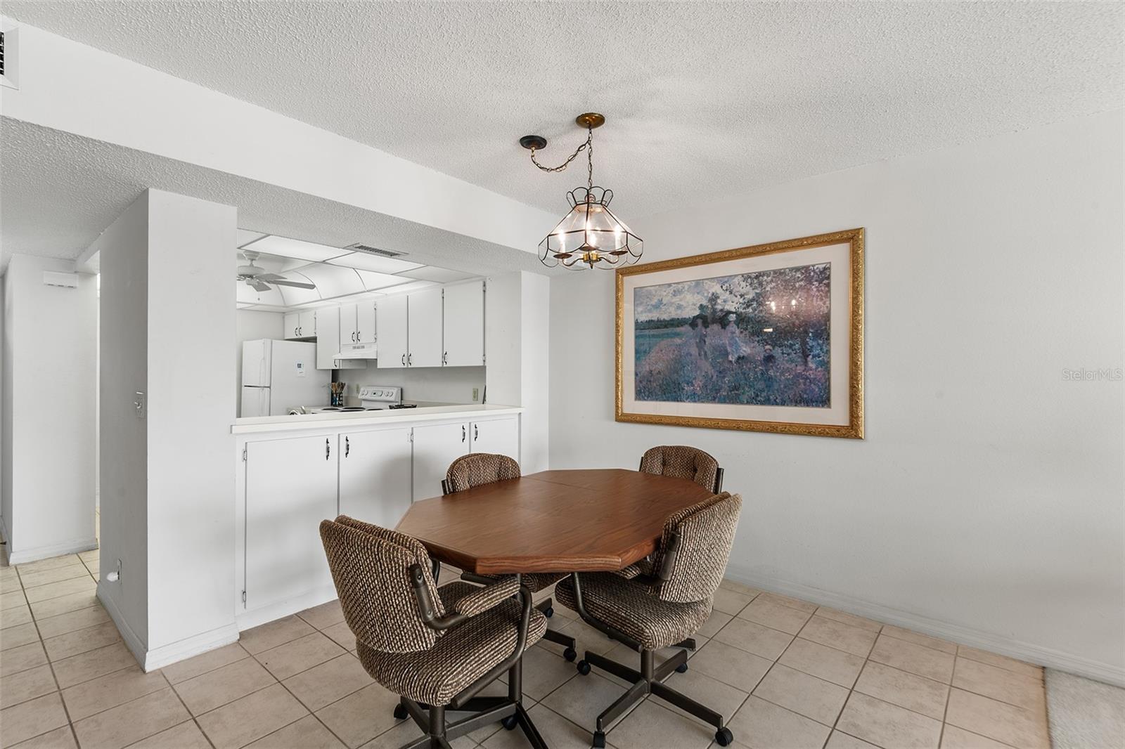 DINING AREA. NOTE EXTRA CABINET STORAGE BELOW PASS THRU FROM KITCHEN