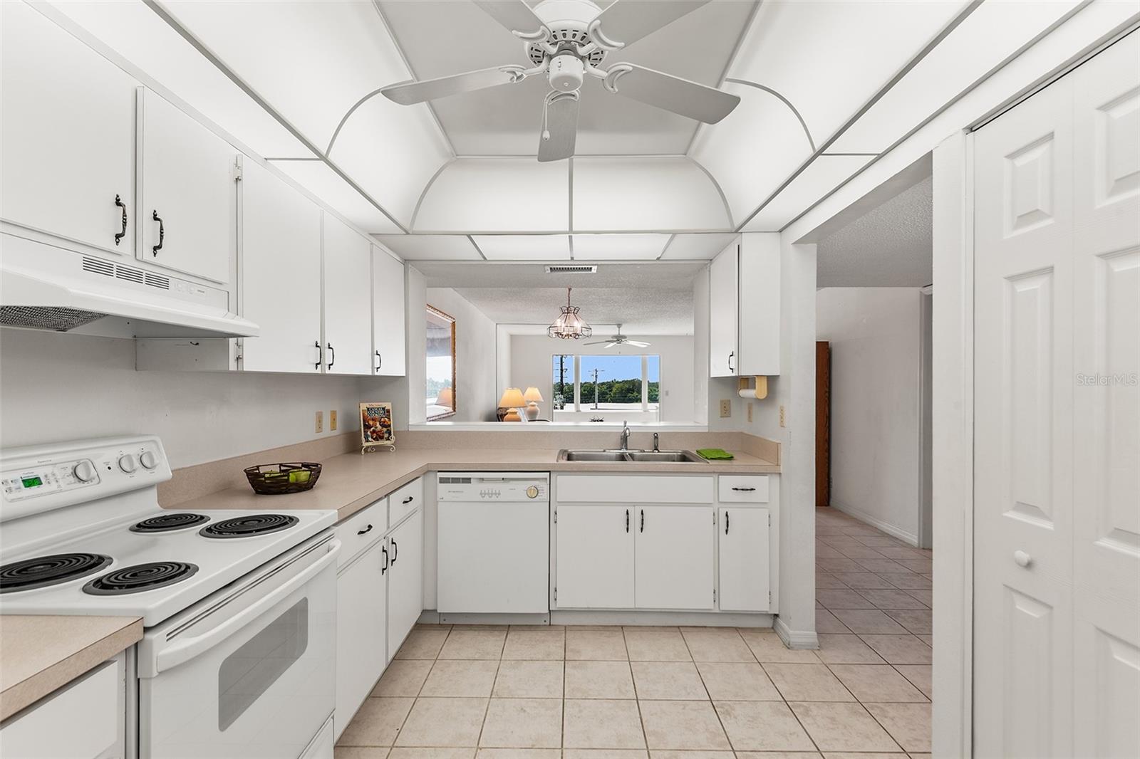 KITCHEN WITH PASS THRU TO DINING AREA. PANTRY CLOSET ON RIGHT.