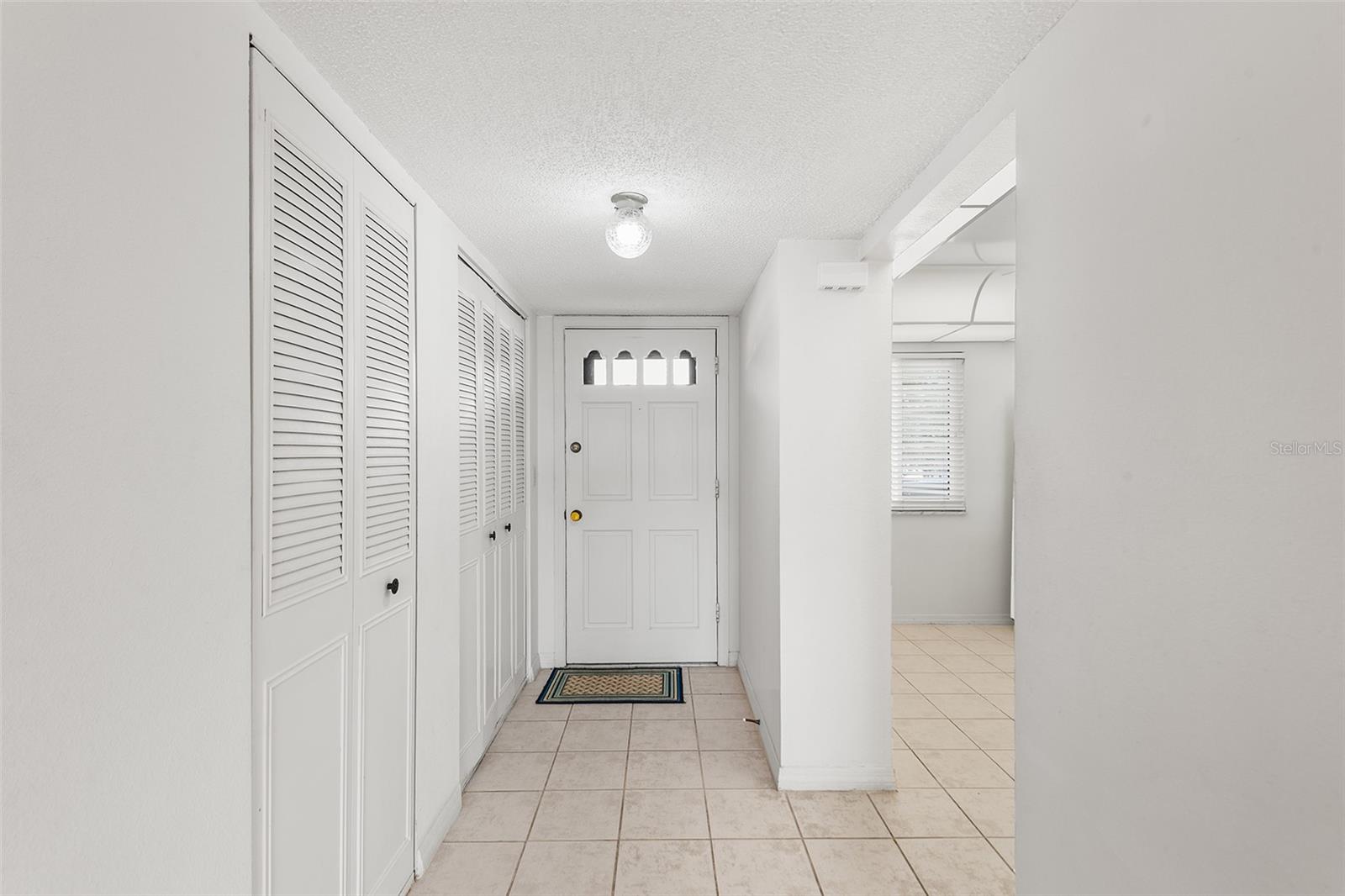VIEW TOWARDS FRONT ENTRY FOYER. CLOSET STORAGE ON LEFT. ENTRY TO KITCHEN ON THE RIGHT.