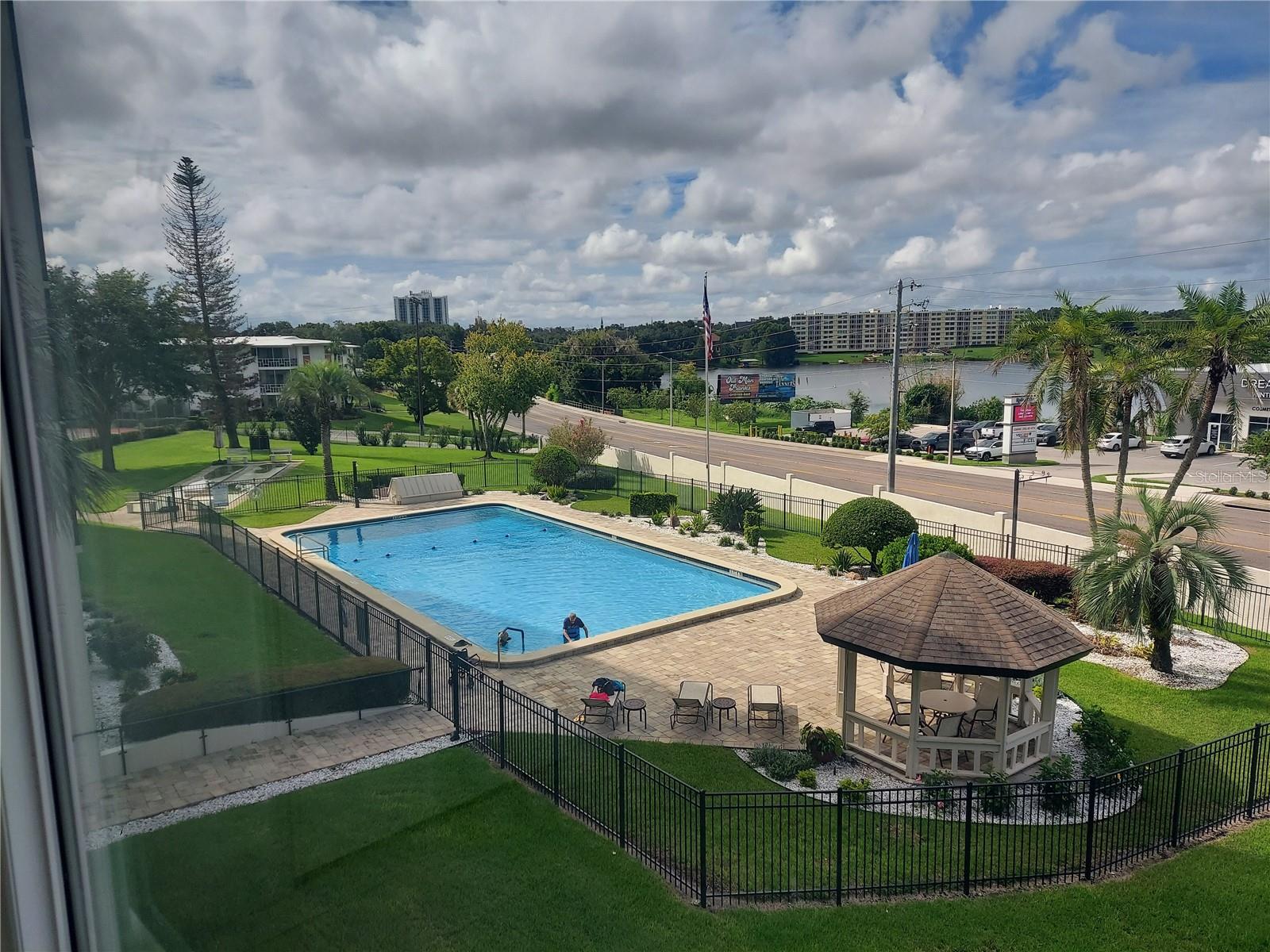 Condo view of pool and lake Condo view of pool and lake