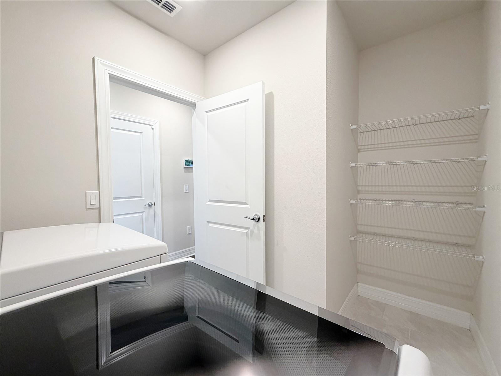 Laundry room offers plenty of storage space