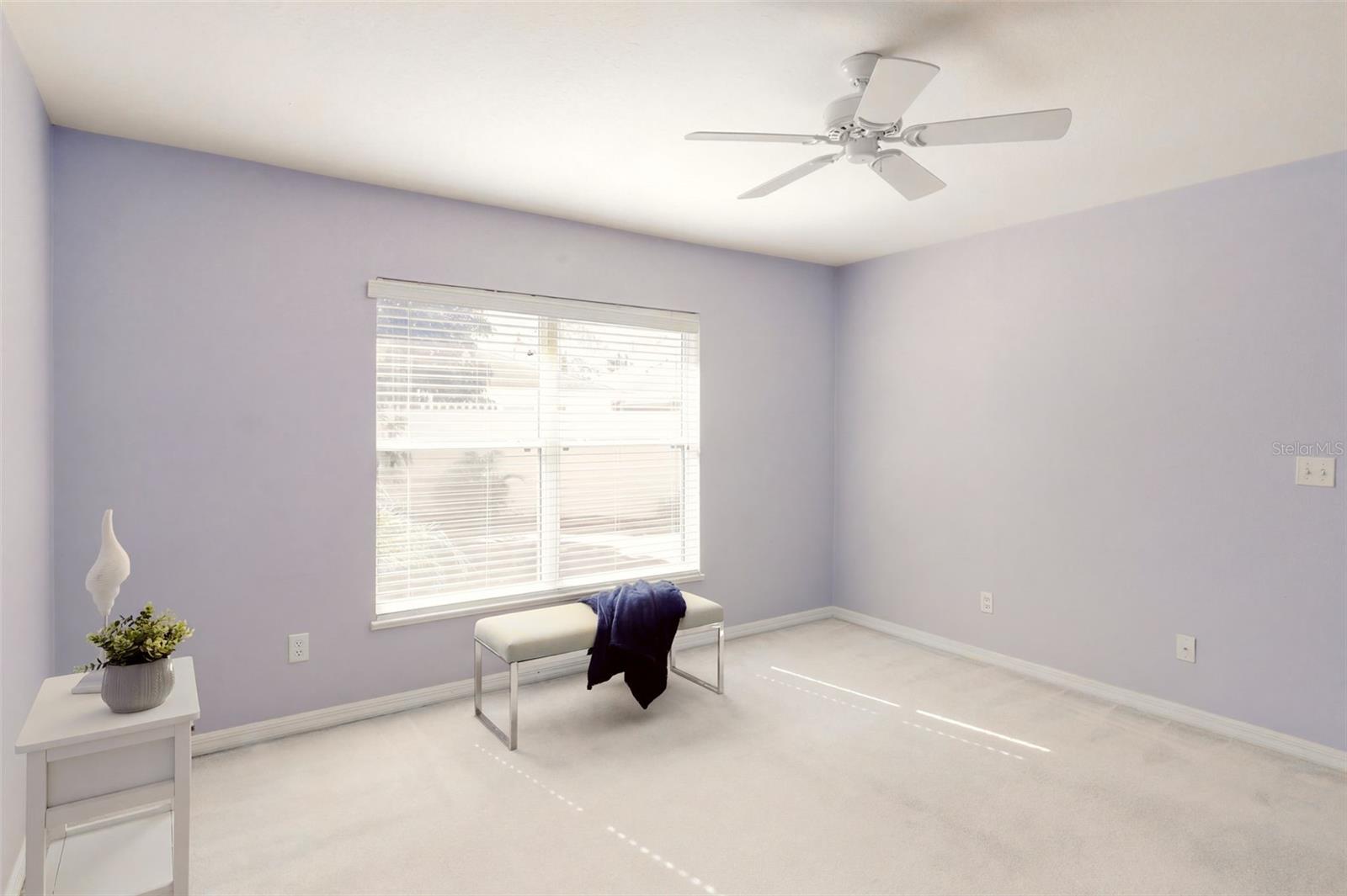 The primary bedroom suite offers serene backyard views